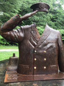 A steel Male uniform saluting with hat
