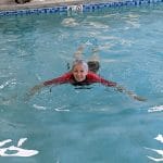 Robin G Coles in an Airtime Waterline wet suit losing her fear of swimming and sculling in a hotel pool