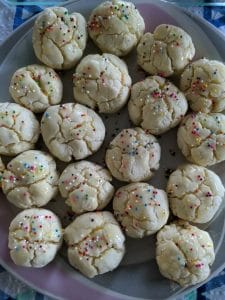 a plate of 12 Italian anise cookies with icing and sprinkles - gluten, dairy and nut free